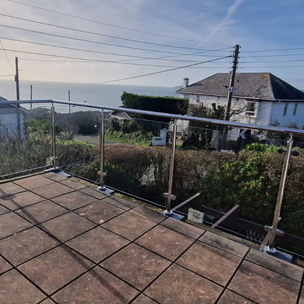Flat roof glass balcony with watertight stanchions